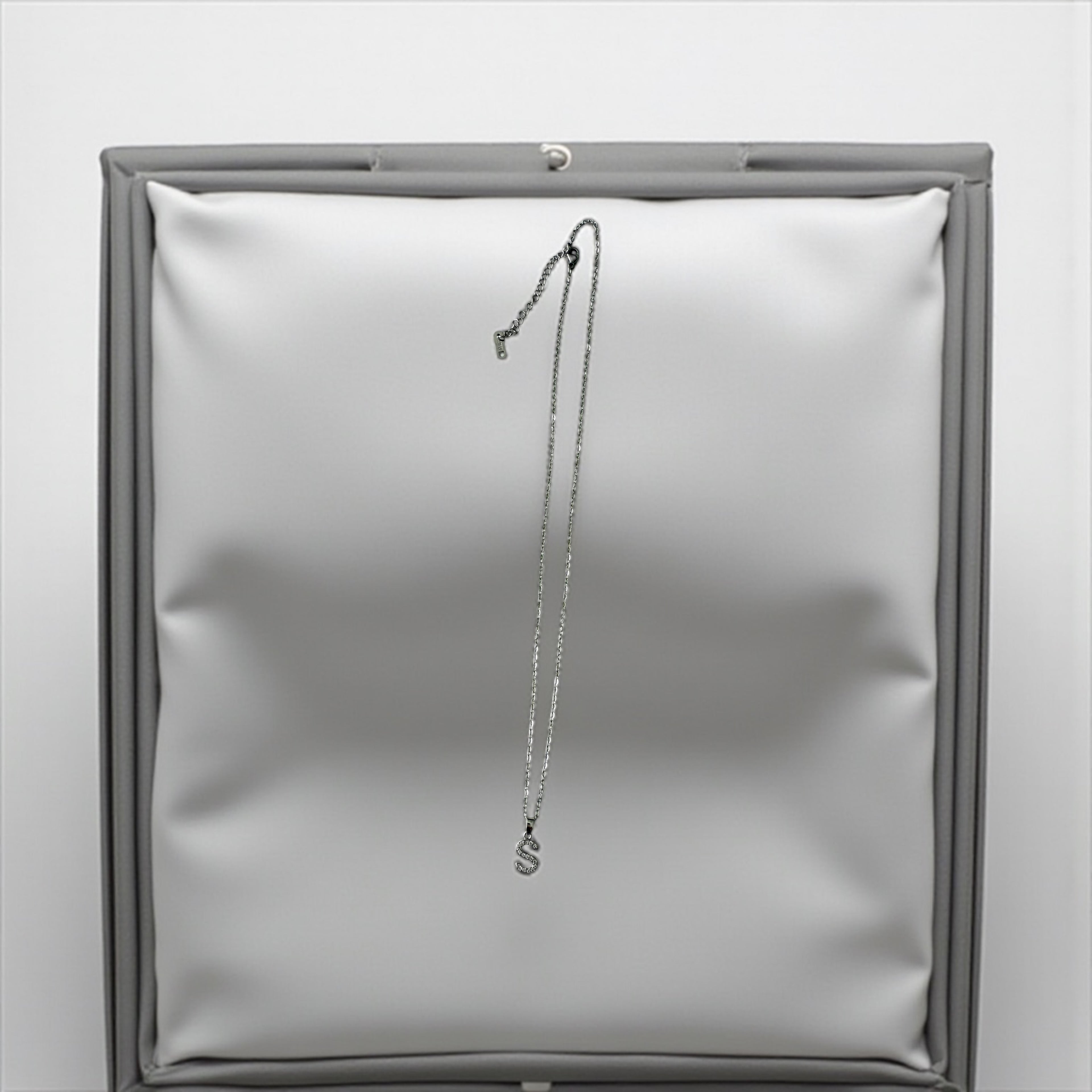 Silver -toned necklace with a crystal-encrusted initial "S" pendant.
