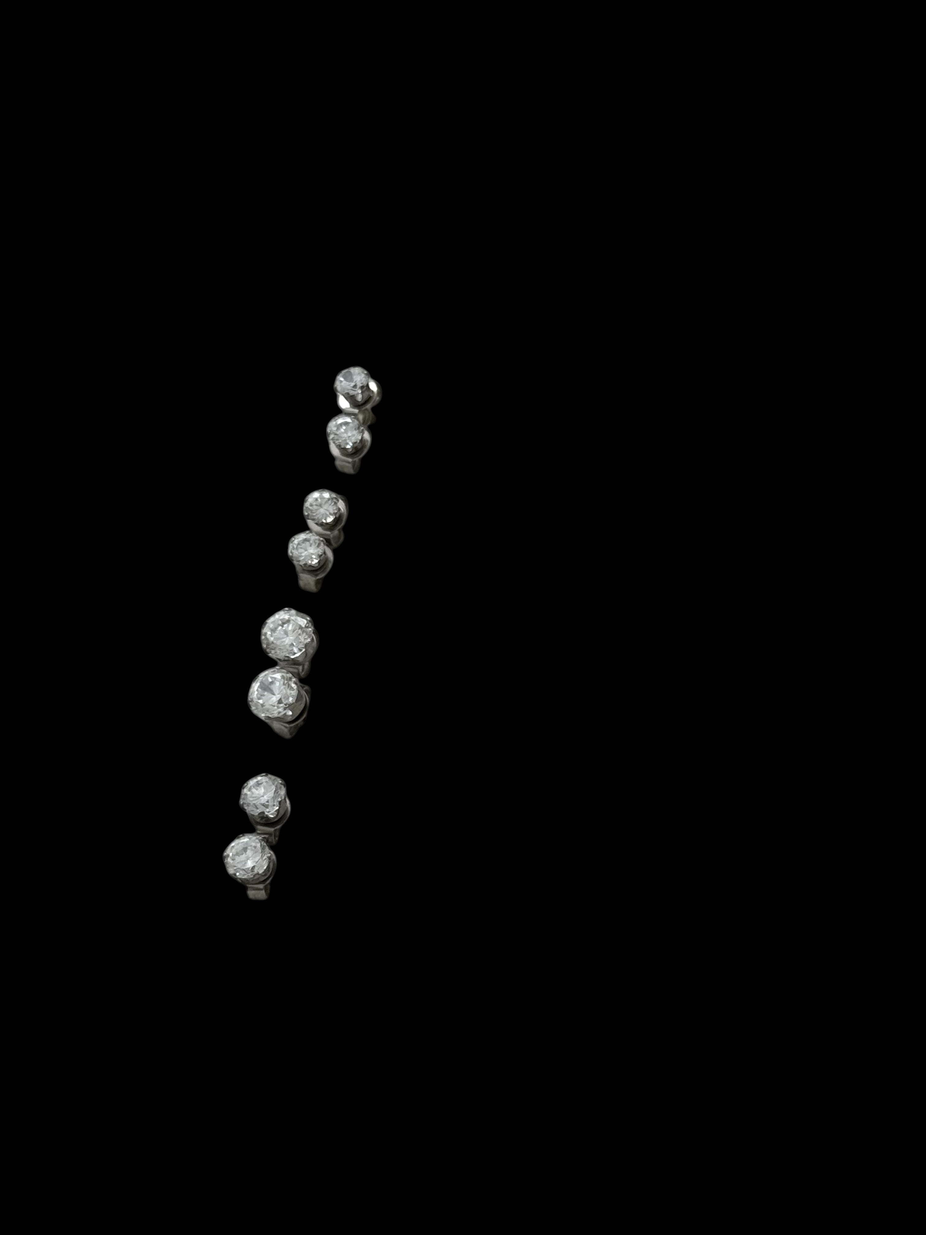 Four pair of silver five-stone diamond climber earrings.