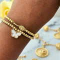 Kendra Scott Haley Bow Gold Stretch Bracelet with an ivory mother-of-pearl charm