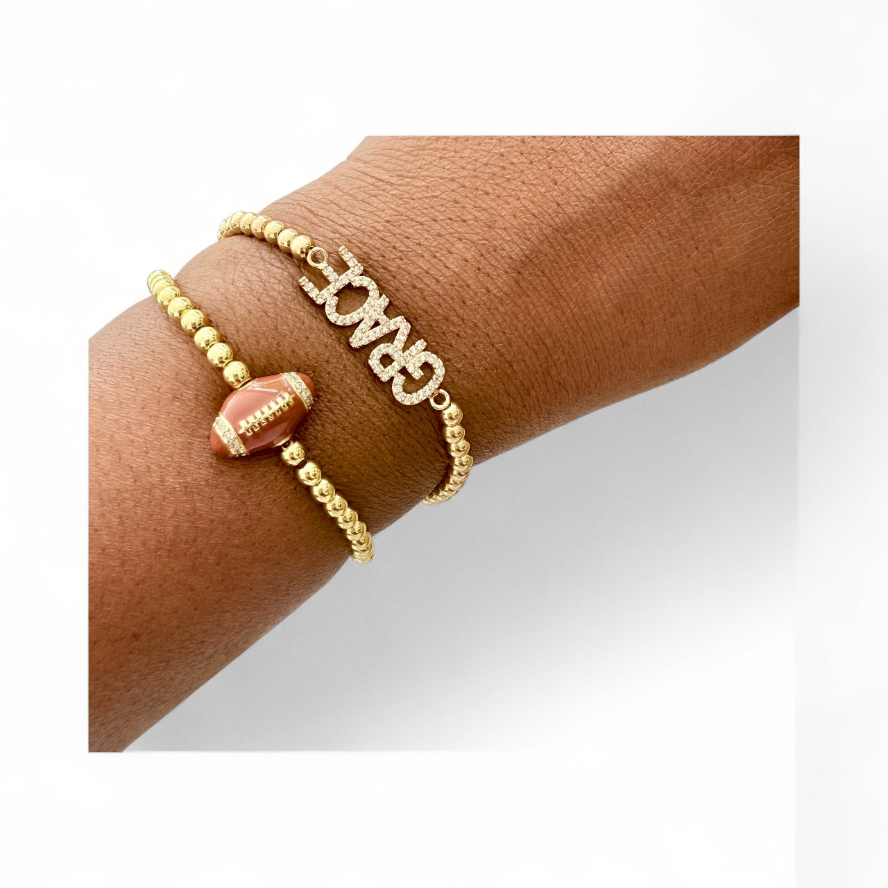 Set of two gold beaded bracelets, one with a football charm and the other with the word "GRACE" spelled out in crystals.