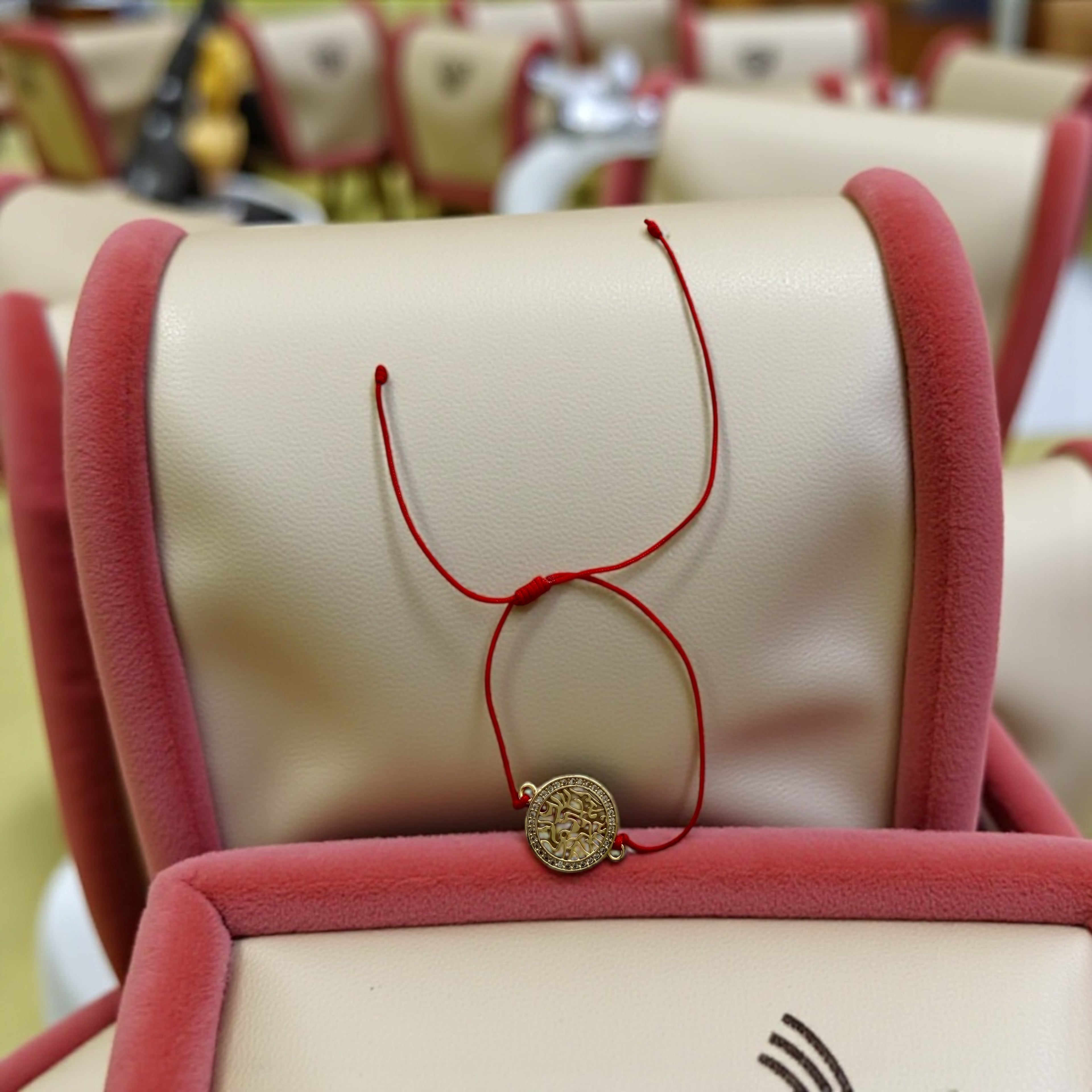 Saint Benedict red cord bracelet with a medal.